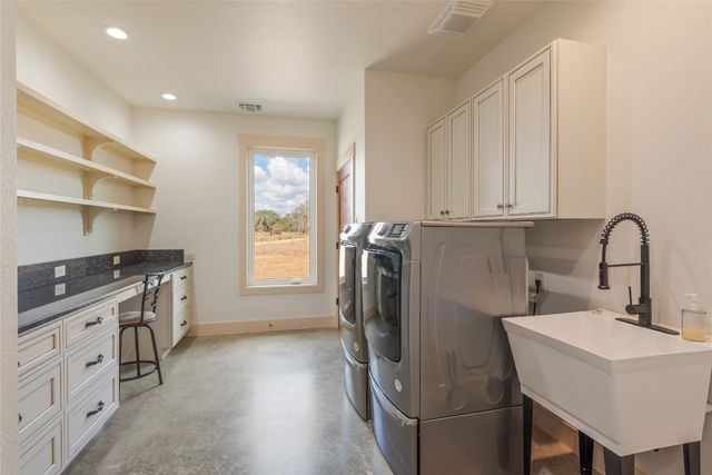 a kitchen with a sink appliances and cabinets