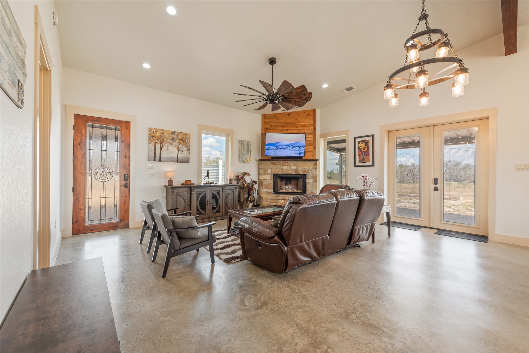 928 Bendele Road Johnson City, TX 78636 - Photo 10 of 31 a living room with furniture a chandelier and a dining room