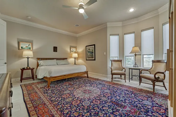 a bedroom with a bed lamps and a dresser