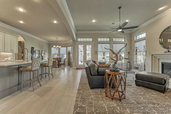 a living room with furniture a large window and a fireplace