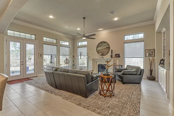 a living room with furniture a large window and stainless steel appliances
