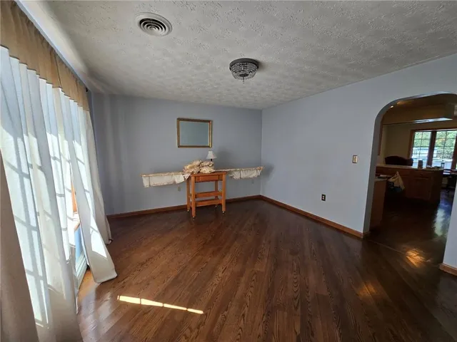 a view of a livingroom with wooden floor and a window