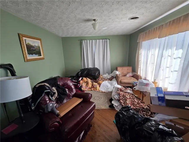 a living room with furniture a window and a chandelier