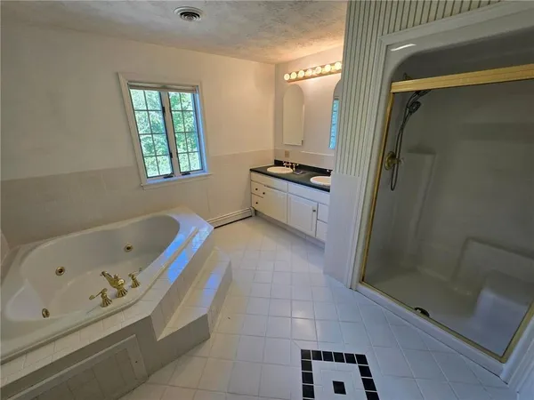 a bathroom with a granite countertop sink a mirror and a shower