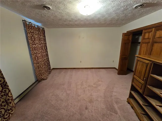 an empty room with closet and mirror