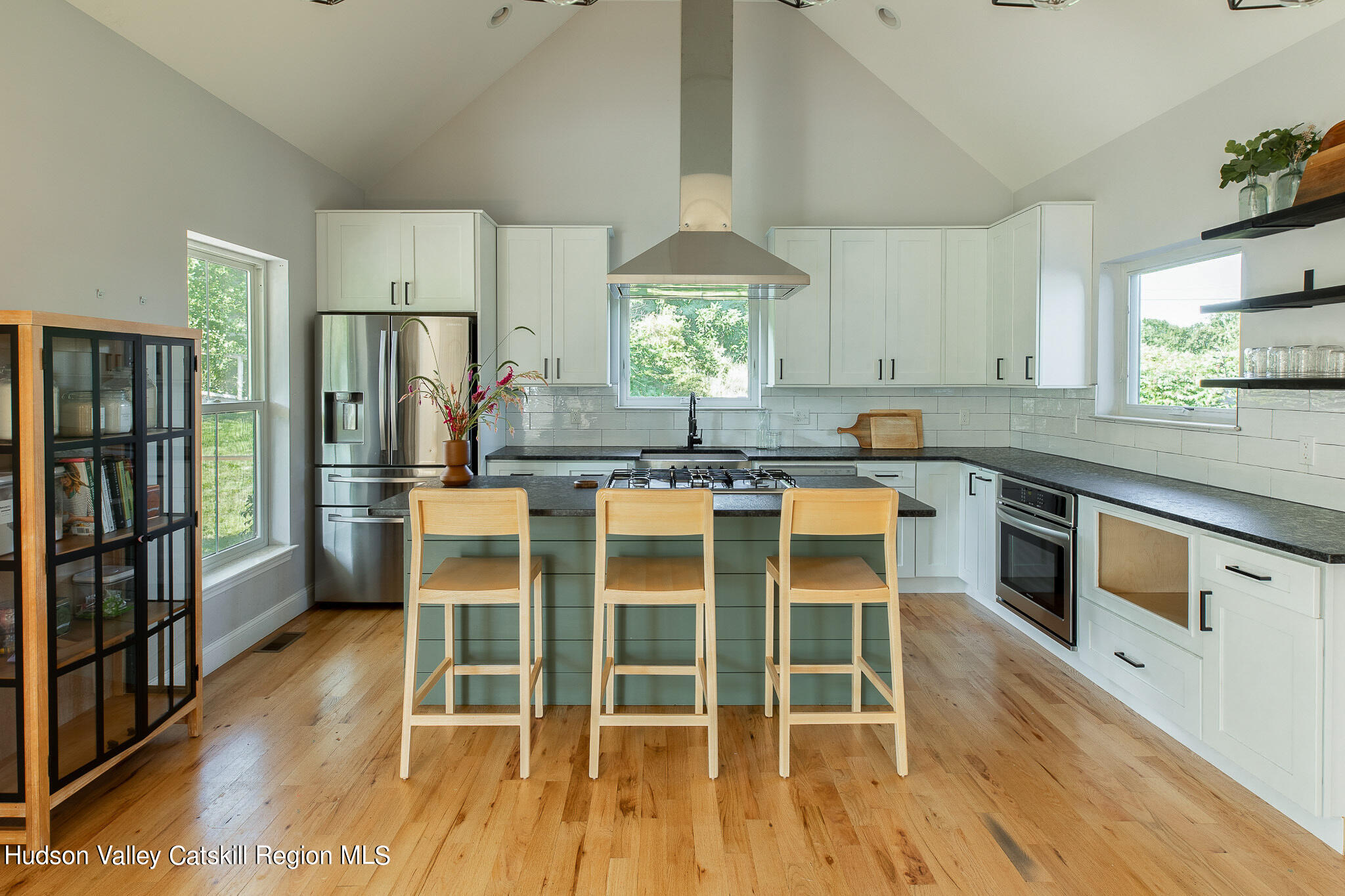 271 Ridge Road Milton, NY 12547 - Photo 7 of 29 a kitchen with stainless steel appliances granite countertop a stove top oven a refrigerator a dining table and chairs with wooden floor