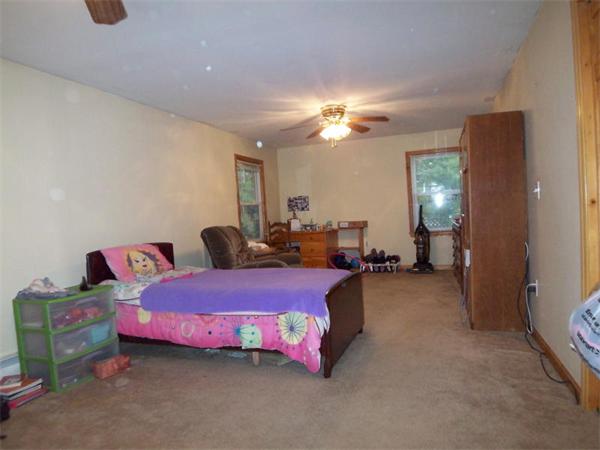 55 School House Road Phillipston, MA 01331 - Photo 12 of 17 a bed room with a bed and a chandelier
