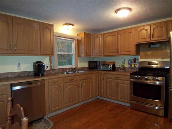 55 School House Road Phillipston, MA 01331 - Photo 3 of 17 a kitchen with granite countertop wooden cabinets and a stove top oven