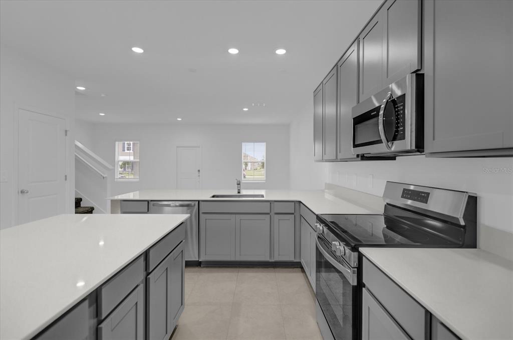 6049 Blissful Street Clermont, FL 34714 - Photo 11 of 25 a kitchen with lots of counter space and a sink