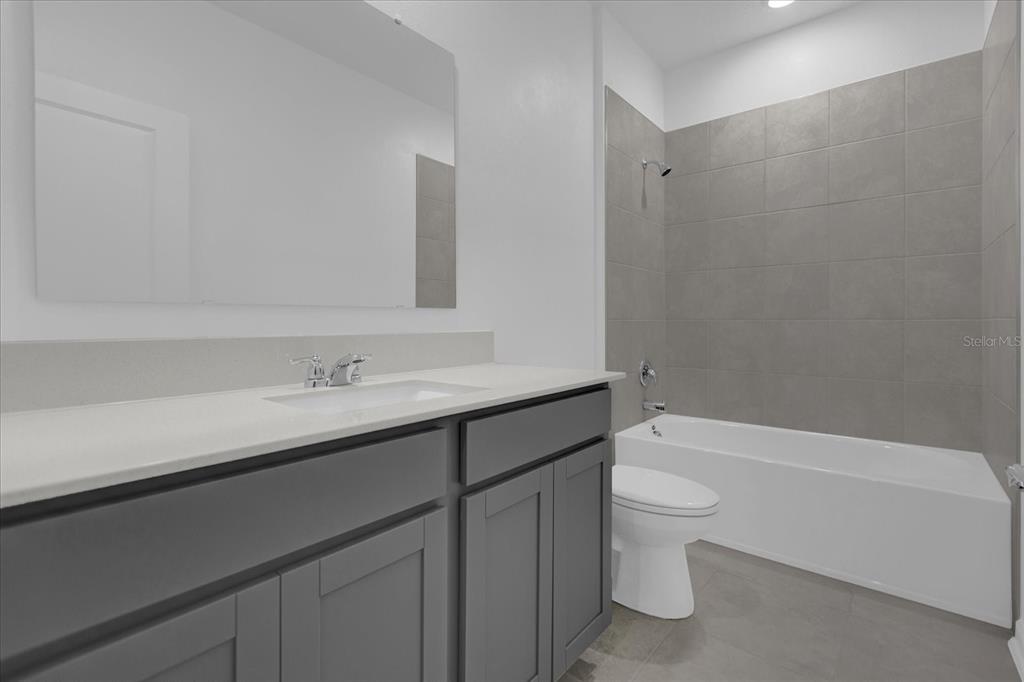 6049 Blissful Street Clermont, FL 34714 - Photo 16 of 25 a bathroom with a sink a toilet and shower