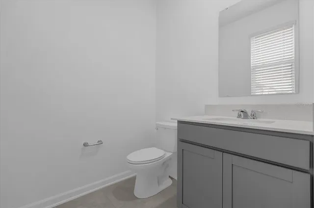 a bathroom with a sink a toilet and a window
