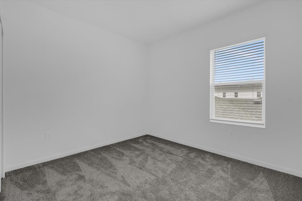 6049 Blissful Street Clermont, FL 34714 - Photo 22 of 25 an empty room with a window