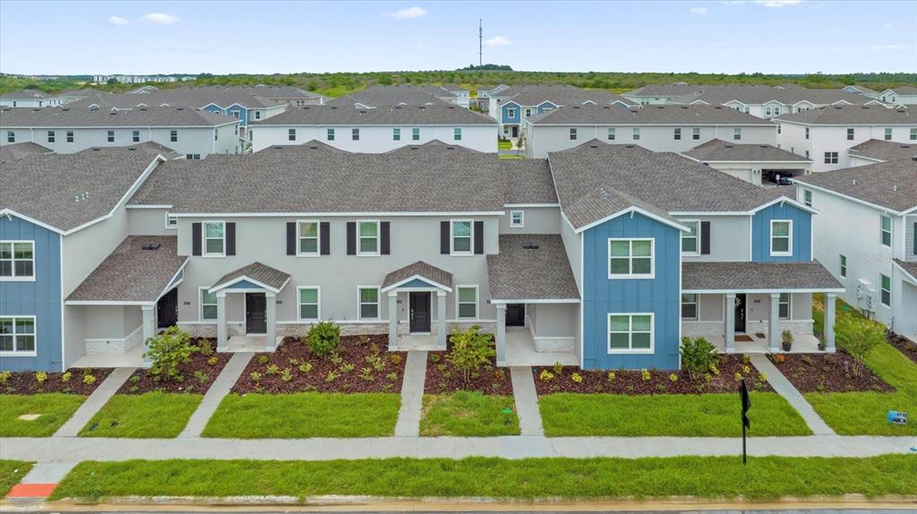 6049 Blissful Street Clermont, FL 34714 - Photo 3 of 25 a front view of residential houses with yard and green space