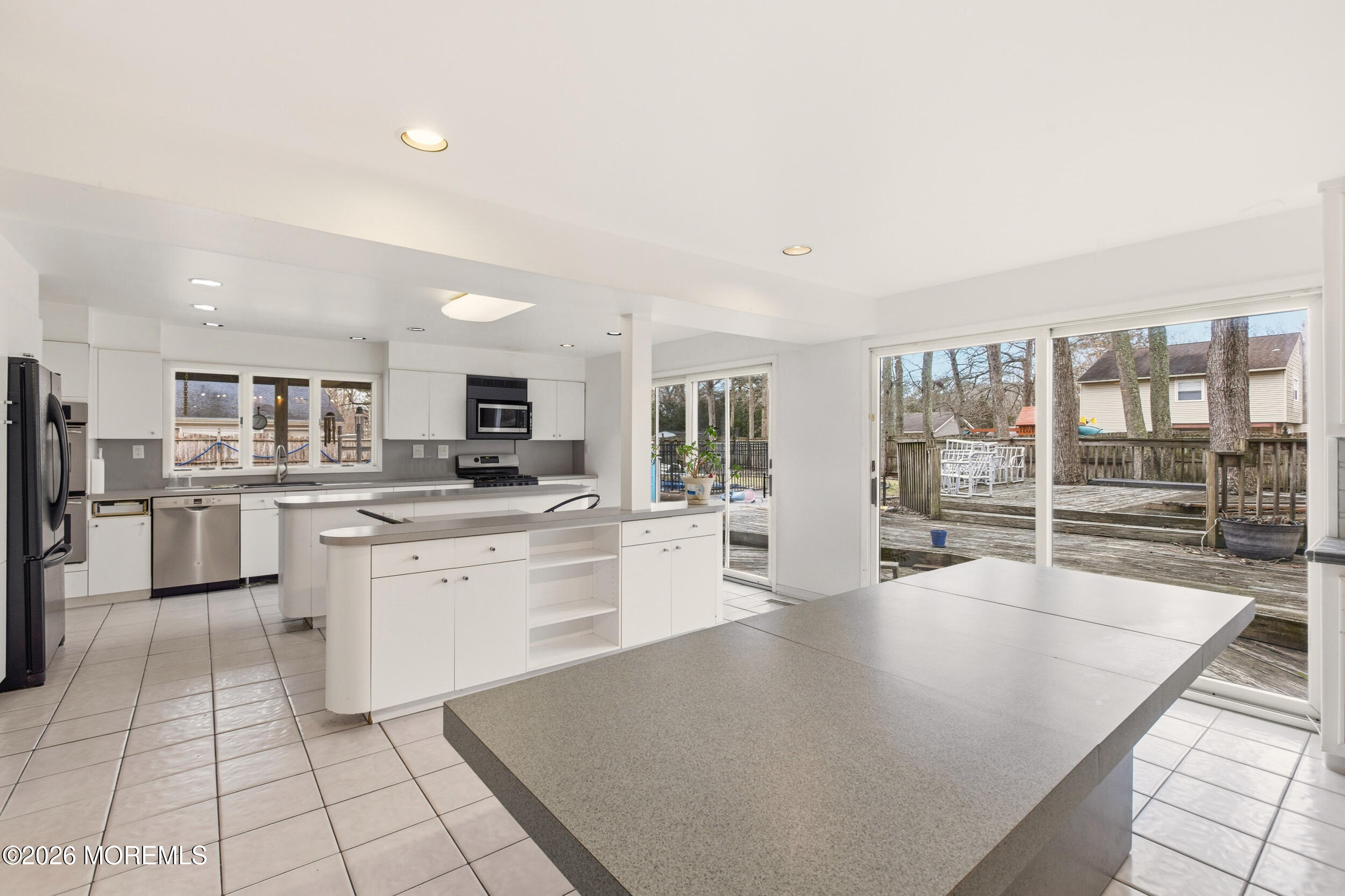 31 Chelsea Road Jackson, NJ 08527 - Photo 26 of 57 a large white kitchen with lots of counter top space a sink and stainless steel appliances