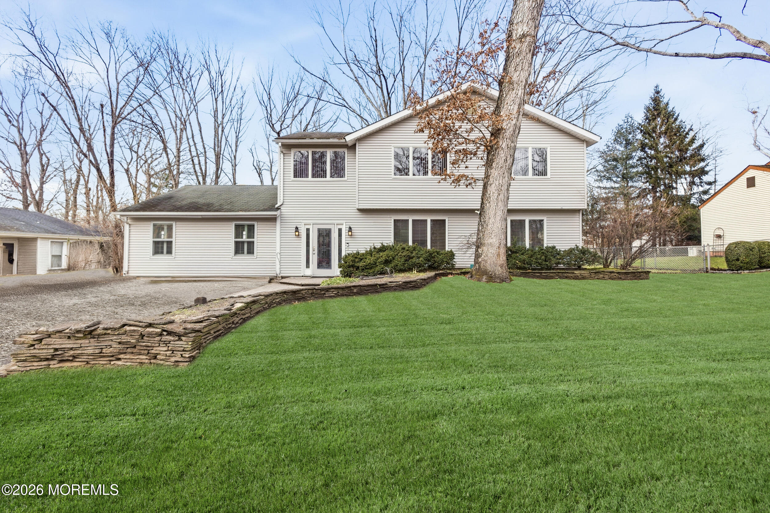 31 Chelsea Road Jackson, NJ 08527 - Photo 52 of 57 a front view of a house with a garden and trees
