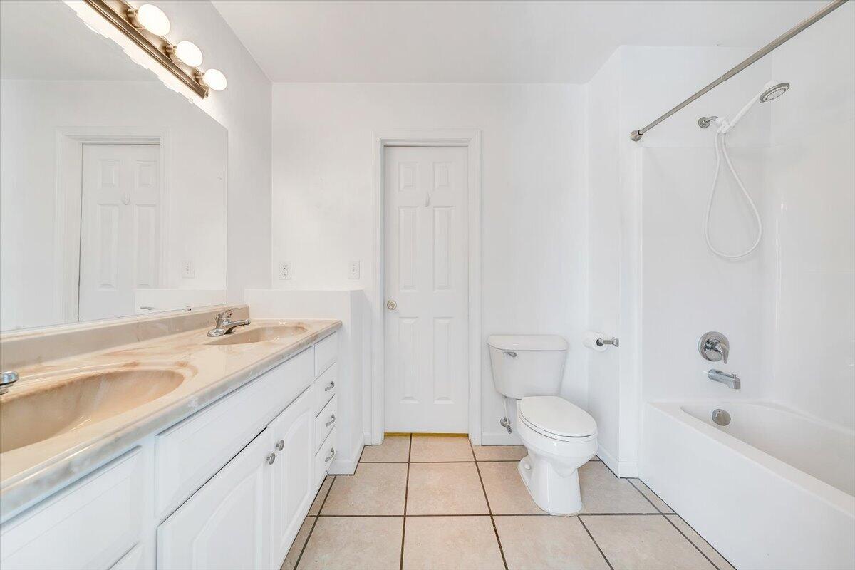 3824 Yellow Mountain Road Southeast Roanoke, VA 24014 - Photo 19 of 50 a spacious bathroom with a granite countertop sink a toilet and a bathtub