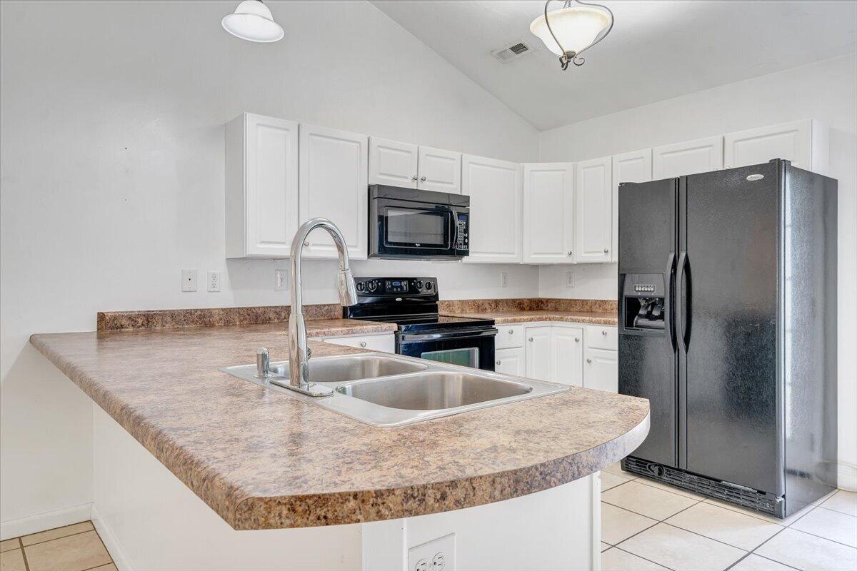 3824 Yellow Mountain Road Southeast Roanoke, VA 24014 - Photo 10 of 50 a kitchen with granite countertop a refrigerator a stove a microwave and island