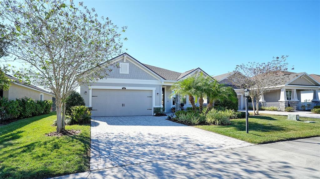 11211 Spring Gate Trail Lakewood Ranch, FL 34211 - Photo 2 of 51 a front view of a house with garden