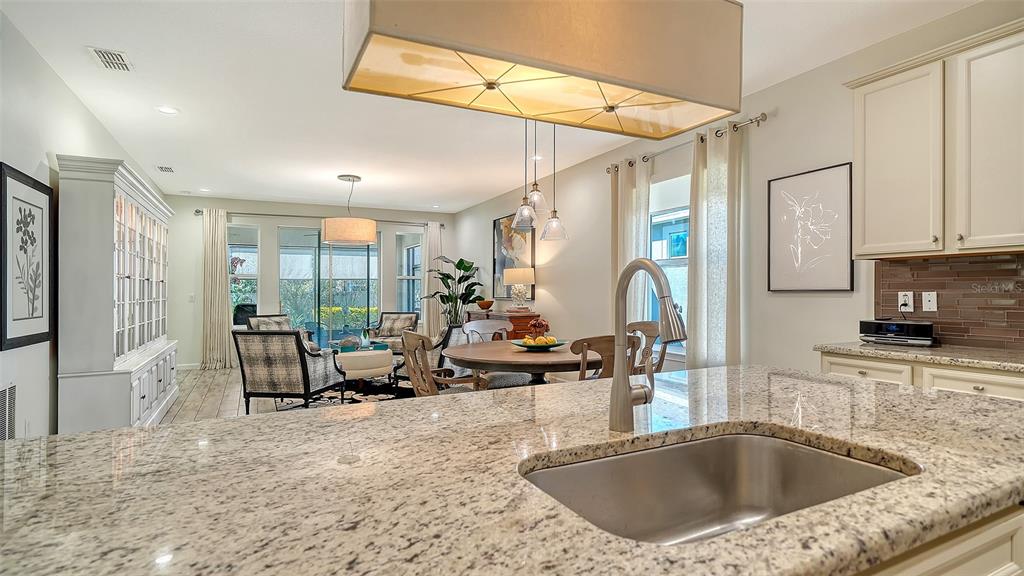 11211 Spring Gate Trail Lakewood Ranch, FL 34211 - Photo 24 of 51 a kitchen with a sink a counter top space and stainless steel appliances