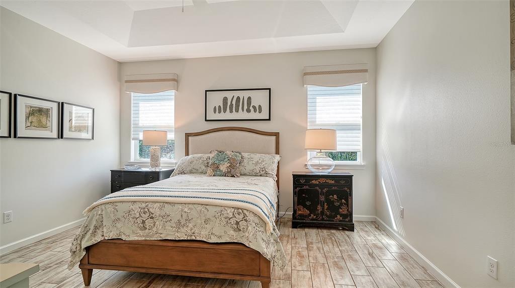 11211 Spring Gate Trail Lakewood Ranch, FL 34211 - Photo 25 of 51 a bedroom with a bed a mirror and a window