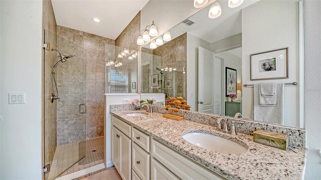 11211 Spring Gate Trail Lakewood Ranch, FL 34211 - Photo 29 of 51 a bathroom with a granite countertop double vanity sink mirror and shower