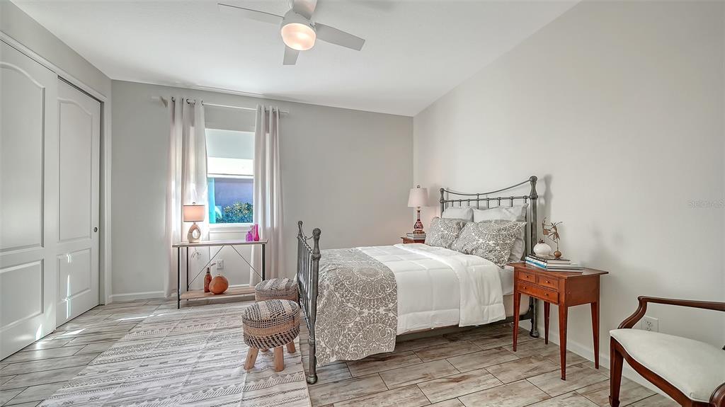 11211 Spring Gate Trail Lakewood Ranch, FL 34211 - Photo 31 of 51 a bedroom with a bed and wooden floor