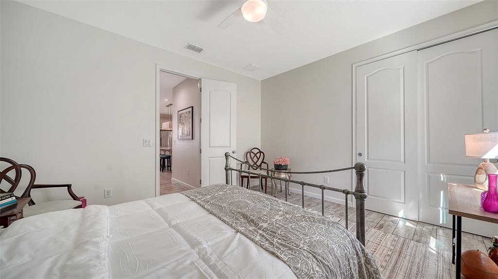 11211 Spring Gate Trail Lakewood Ranch, FL 34211 - Photo 32 of 51 a bedroom with a bed and a chandelier