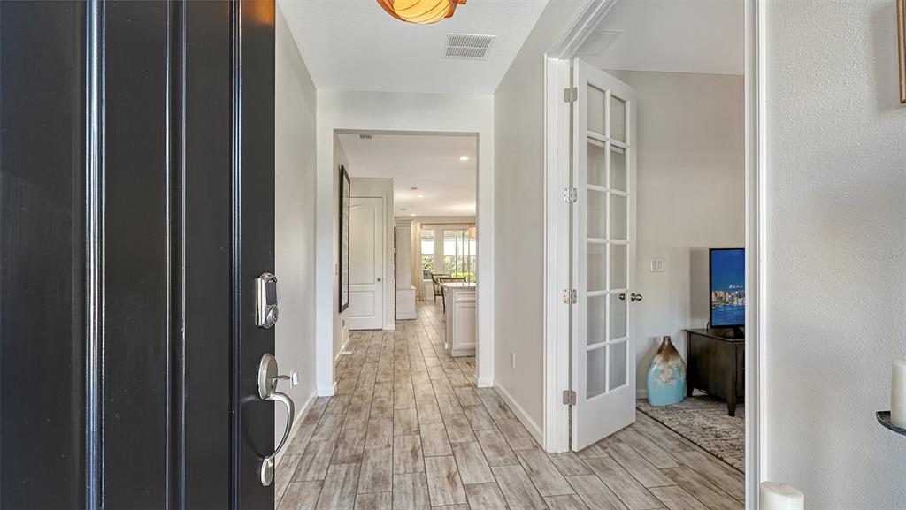 11211 Spring Gate Trail Lakewood Ranch, FL 34211 - Photo 6 of 51 a view of a hallway with wooden floor and closet