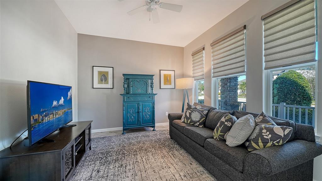 11211 Spring Gate Trail Lakewood Ranch, FL 34211 - Photo 7 of 51 a living room with furniture and a flat screen tv