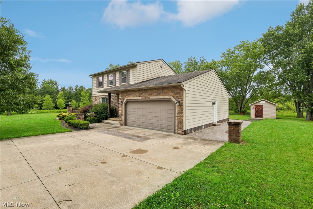4702 Alger Road Richfield, OH 44286 - Photo 2 of 46 Front / side of property with a 2 car attached garage, concrete driveway, large yard and shed