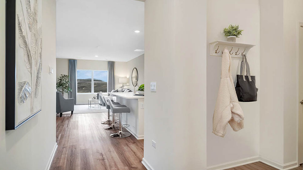 1114 Bluebell Lane Bartlett, IL 60103 - Photo 2 of 16 a view of a hallway with wooden floor and dining room view