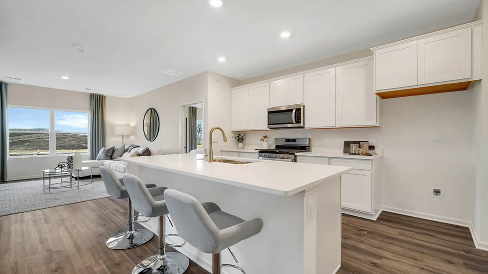 1114 Bluebell Lane Bartlett, IL 60103 - Photo 6 of 16 a kitchen with kitchen island a stove a table and chairs in it