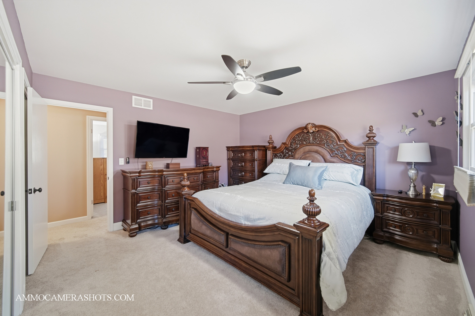 817 Woodland Hills Road Batavia, IL 60510 - Photo 17 of 38 a spacious bedroom with a bed and a flat tv screen on dresser