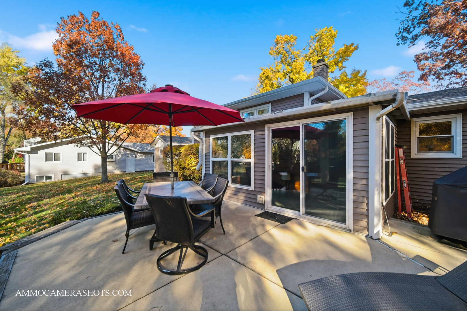 817 Woodland Hills Road Batavia, IL 60510 - Photo 26 of 38 a view of a patio with a table and chairs under an umbrella