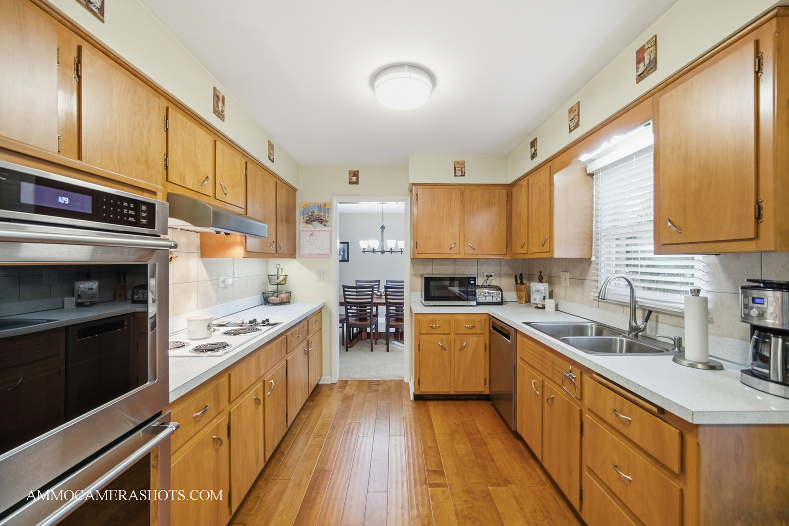 817 Woodland Hills Road Batavia, IL 60510 - Photo 8 of 38 a kitchen with stainless steel appliances a stove sink cabinets and wooden floor