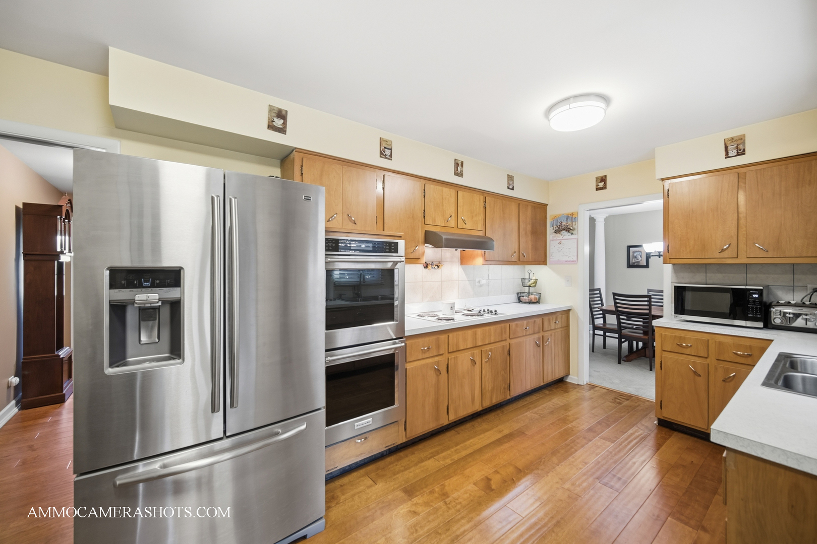 817 Woodland Hills Road Batavia, IL 60510 - Photo 10 of 38 a kitchen with granite countertop stainless steel appliances and wooden cabinets