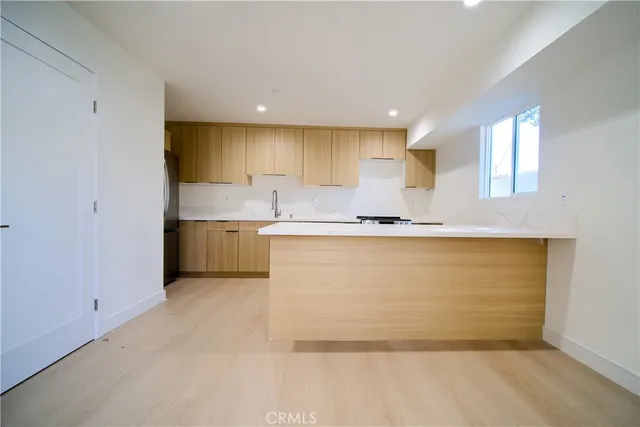 a view of kitchen with granite countertop cabinets and sink
