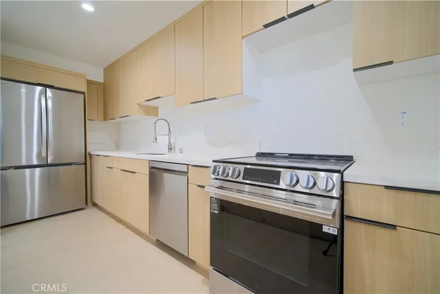 a kitchen with white cabinets and white appliances