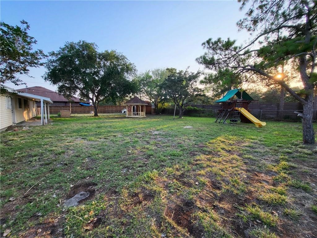 3802 Matteson Street Corpus Christi, TX 78418 - Photo 14 of 14 a view of a tree in a backyard of a house