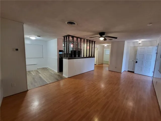 a view of a hallway with wooden floor