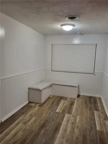 a view of a room with wooden floor