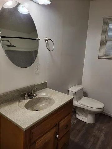 a bathroom with a sink toilet and a mirror