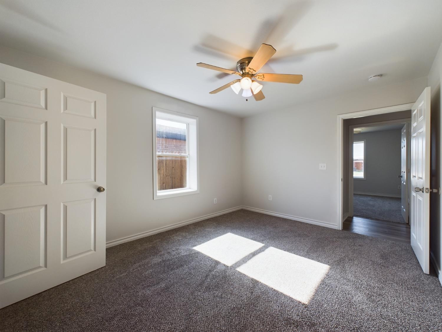 6306 25th Street Lubbock, TX 79407 - Photo 15 of 37 an empty room with windows and fan