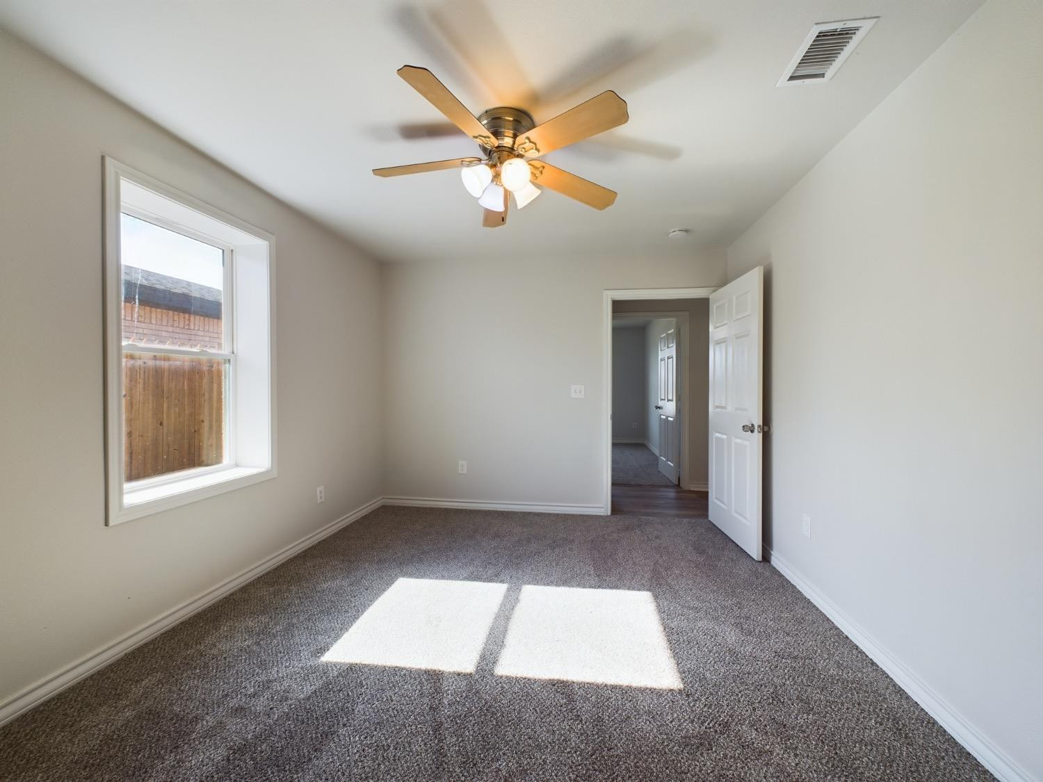 6306 25th Street Lubbock, TX 79407 - Photo 16 of 37 an empty room with fan and windows