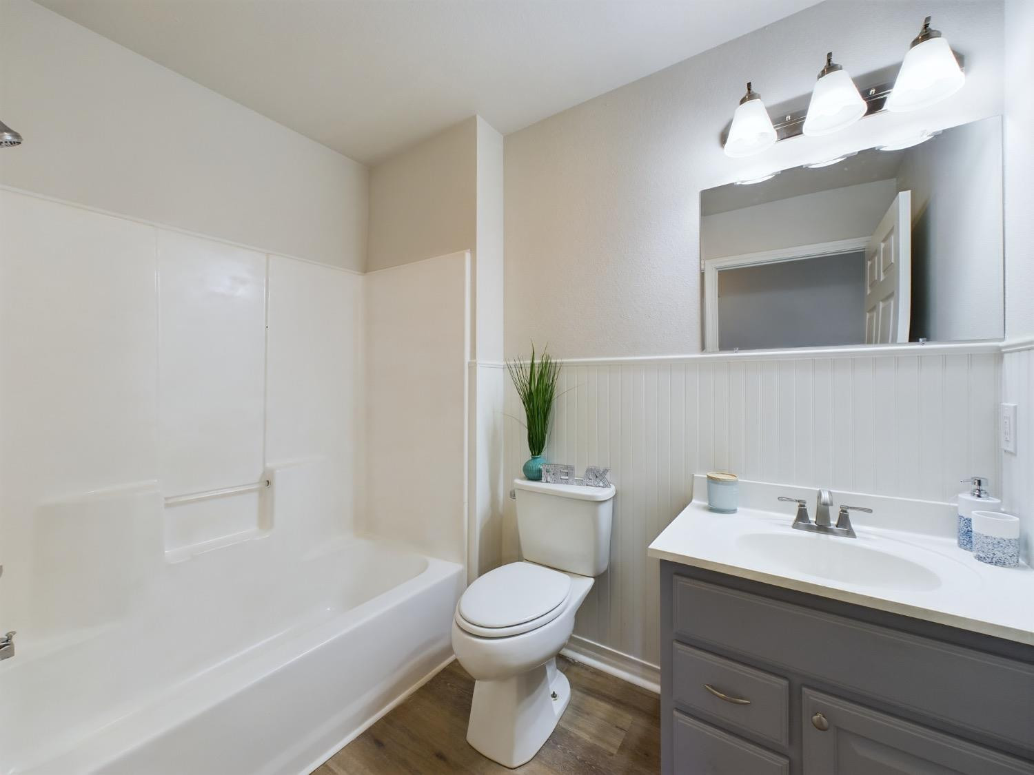6306 25th Street Lubbock, TX 79407 - Photo 18 of 37 a bathroom with a sink a toilet and a mirror