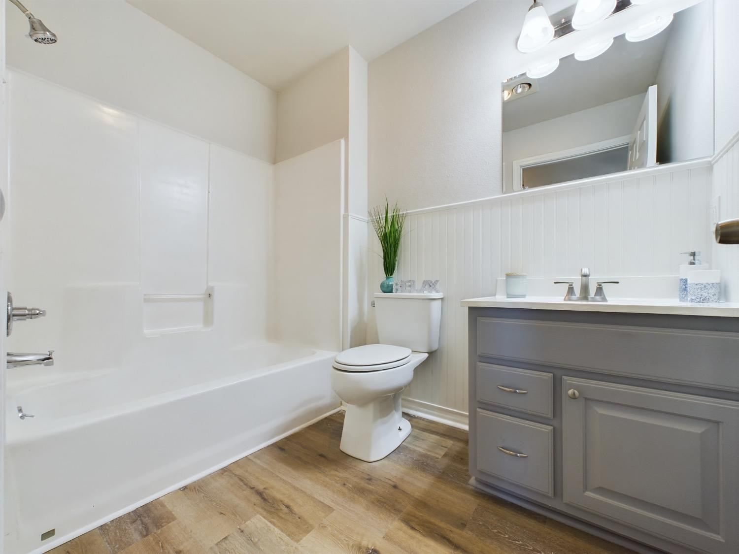6306 25th Street Lubbock, TX 79407 - Photo 19 of 37 a bathroom with a sink a toilet and a bathtub