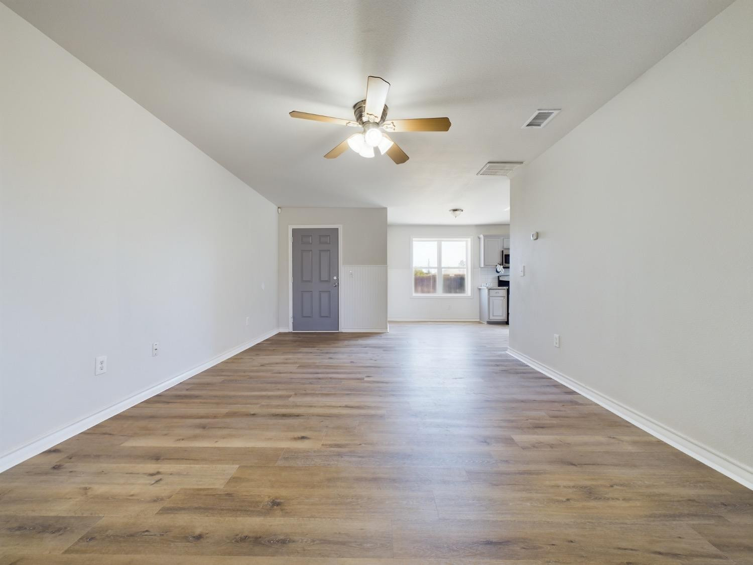 6306 25th Street Lubbock, TX 79407 - Photo 20 of 37 a view of empty room with wooden floor and fan