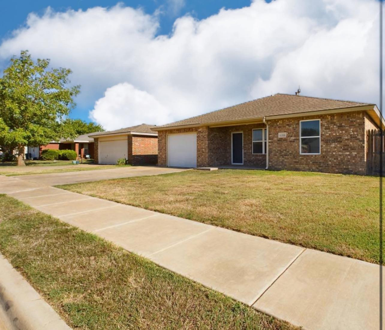 6306 25th Street Lubbock, TX 79407 - Photo 2 of 37 a front view of a house with a yard
