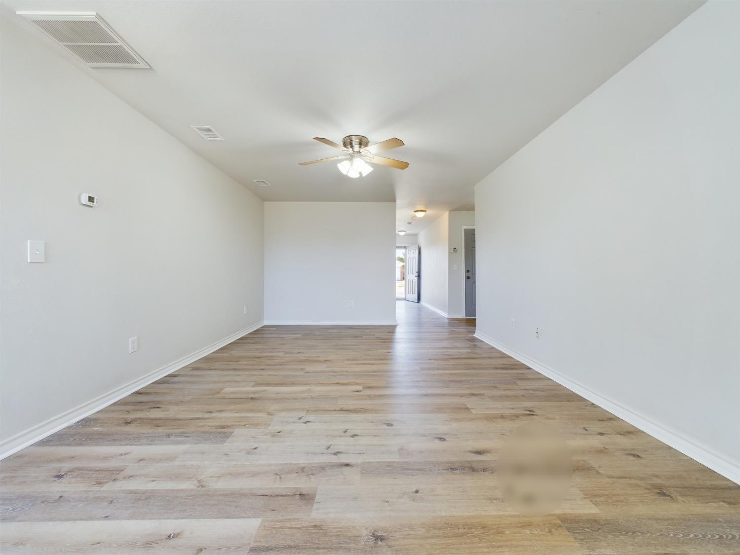 6306 25th Street Lubbock, TX 79407 - Photo 21 of 37 a view of an empty room with a ceiling fan and window