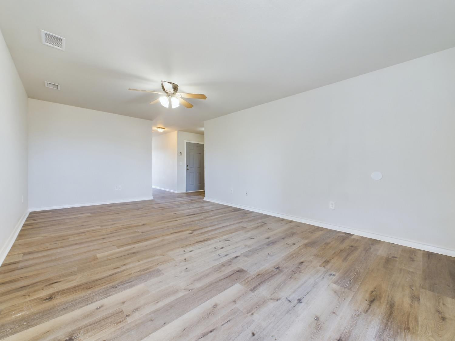 6306 25th Street Lubbock, TX 79407 - Photo 22 of 37 a view of a room with wooden floor and a ceiling fan